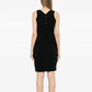Black wool sleeveless sheath dress by Chanel, showcasing a fitted silhouette and elegant design on a model.