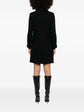 Black Chanel wool tweed coat, stylish and elegant, featuring classic textured fabric and tailored design ideal for sophisticated winter wear.
