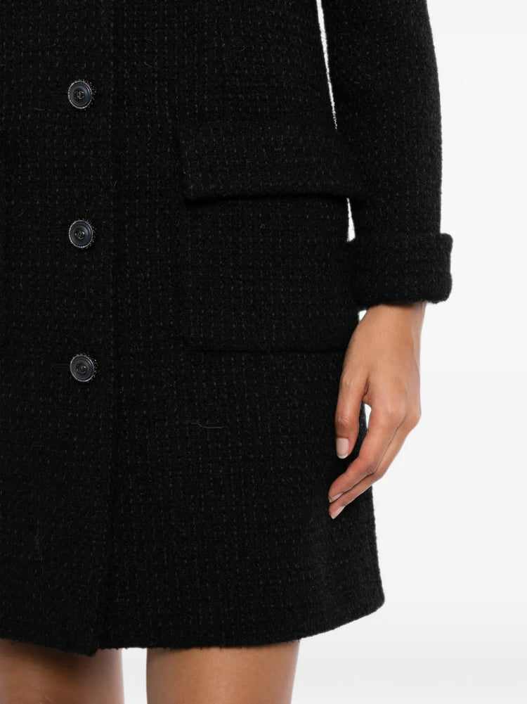 Black Chanel wool tweed coat made of classic textured fabric, stylish long coat with a tailored fit and elegant design.