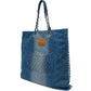 Chanel blue denim shopper bag with chain-and-denim shoulder straps, silver-tone CC charm, faded denim finish and rear quilted pocket with logo plaque.