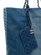 Chanel denim shopper bag with top handle, featuring classic design and durable denim material for versatile style.
