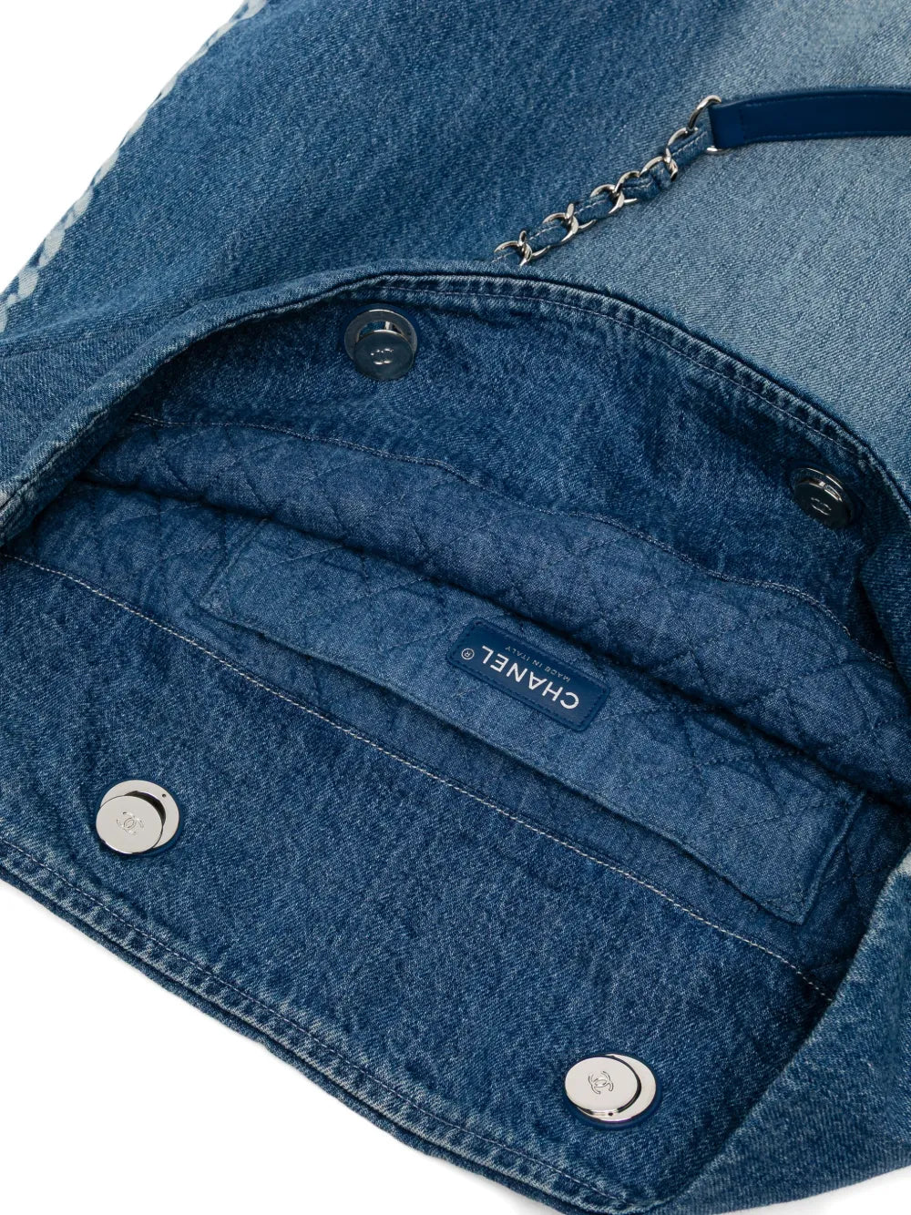 Chanel denim shopper bag with top handle, featuring classic stitching and spacious interior, stylish and functional for everyday use.