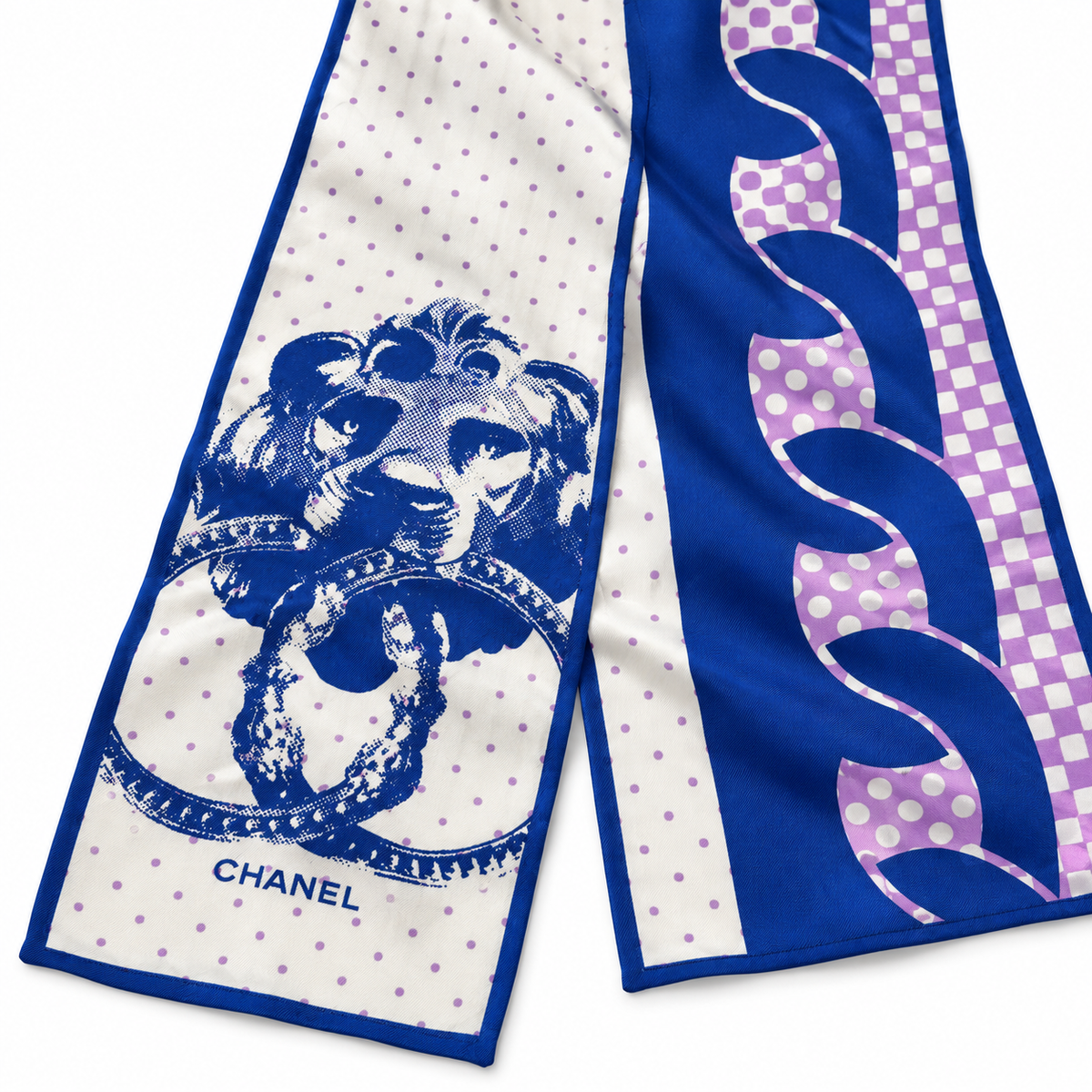 Chanel blue, ivory and violet silk scarf with polka dot print, graphic wave pattern and decorative chain and floral motif.
