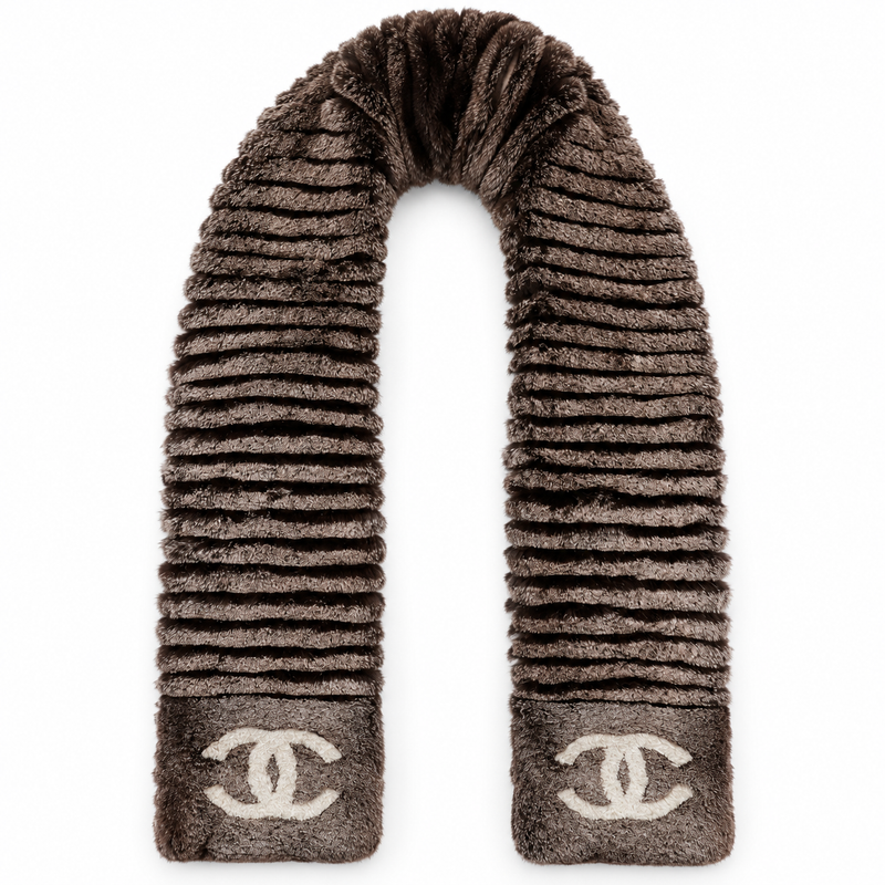 Chanel Orylag and fabric CC scarf draped elegantly, showcasing luxurious textures and classic design with Chanel branding.