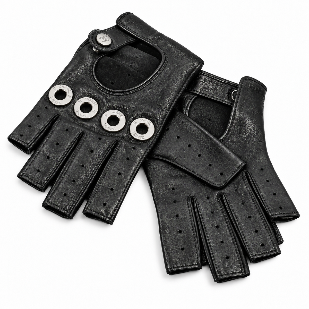 Black lambskin fingerless gloves by Chanel, stylish and soft, shown close-up with textured leather details.