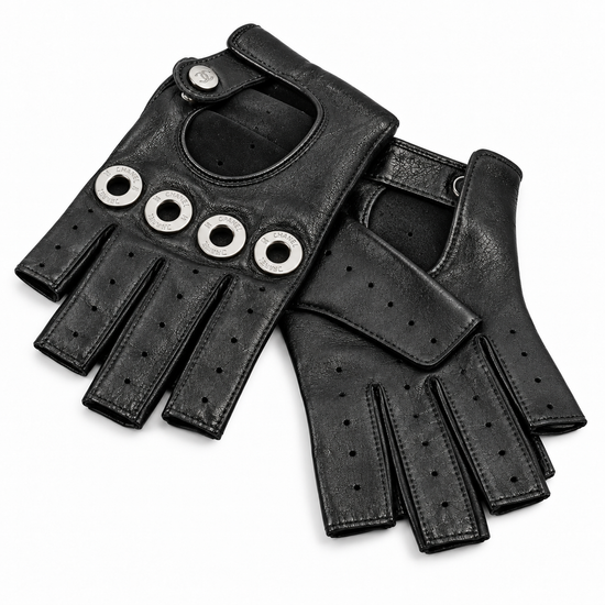 Black lambskin fingerless gloves by Chanel, stylish and soft, shown close-up with textured leather details.