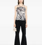 Chanel monochrome printed silk halterneck top with sleek design and stylish pattern, showcased on a model.