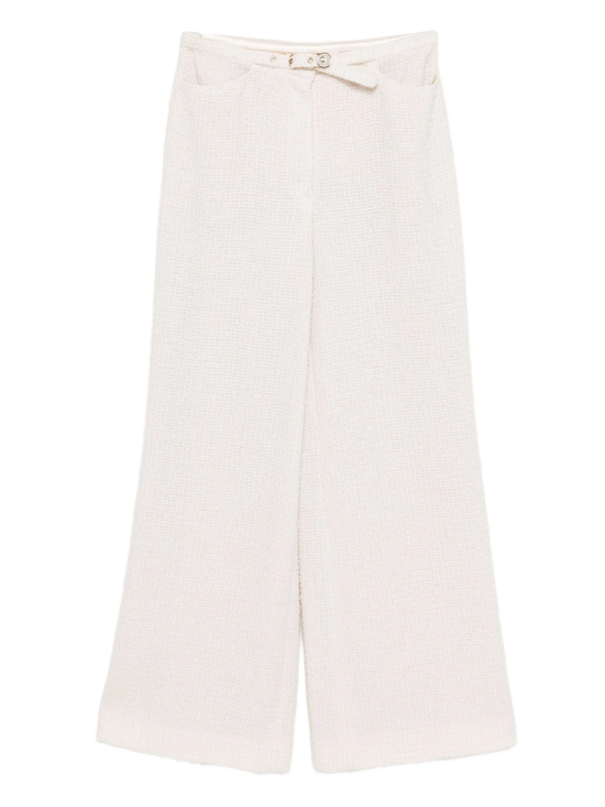 Cream Chanel tweed trousers with tailored fit and classic design, featuring textured fabric and elegant style.
