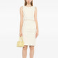Chanel sleeveless cream wool tweed dress with fitted silhouette and classic round neckline, displayed on a mannequin.