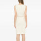 Cream sleeveless wool tweed dress by Chanel, showcasing classic tailored fit and textured fabric with elegant sleeveless design.