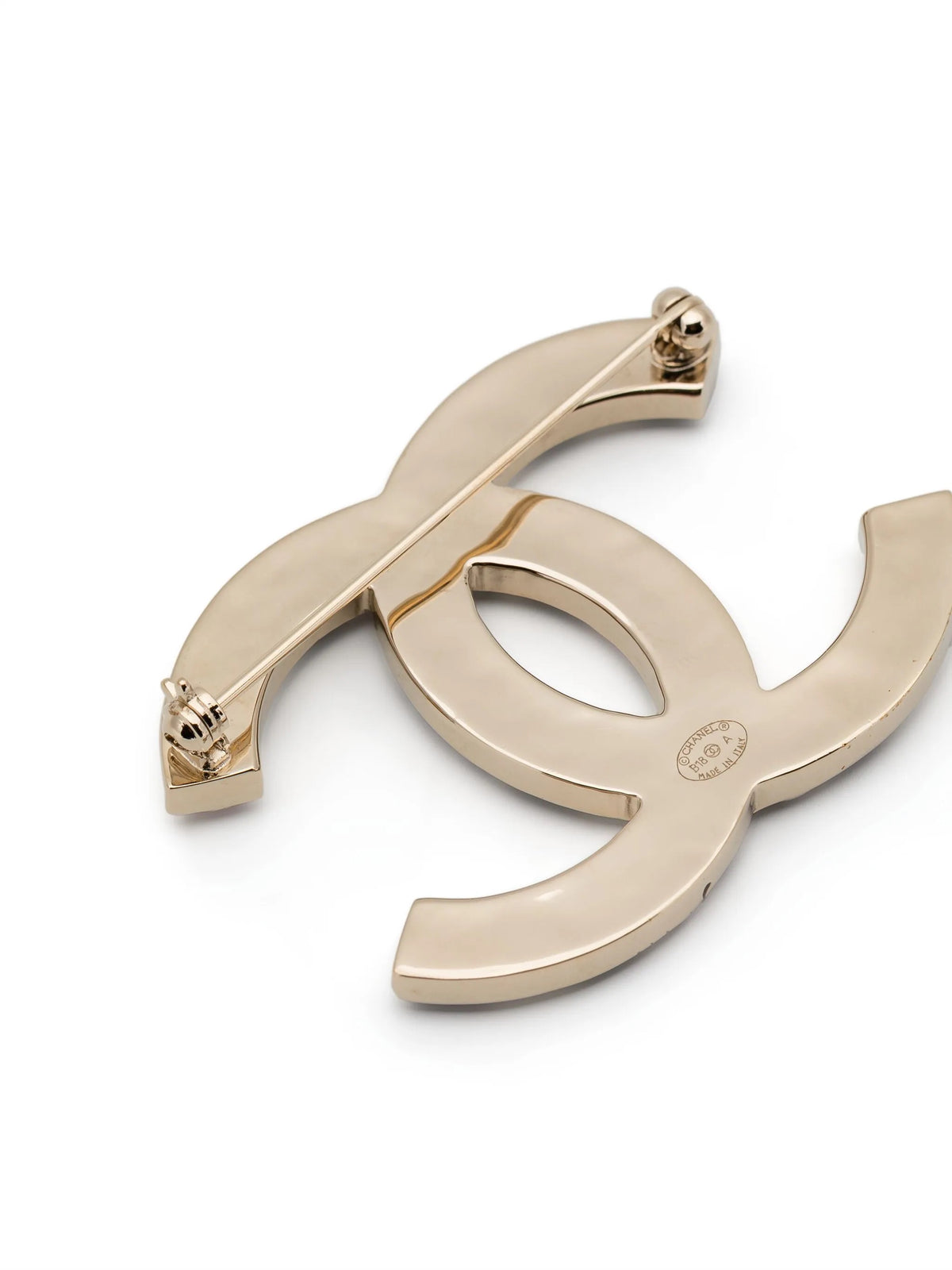 Chanel crystal enamel stripe brooch with colorful designs and gold-tone pin on a white background