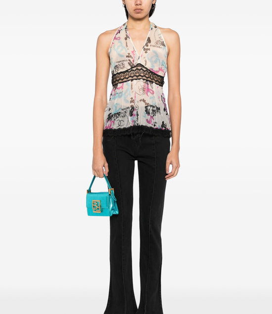 Chanel ivory silk halterneck top with multicolour graffiti print, deep V neckline, black lace underbust trim, flared silhouette and Chanel CC motifs.