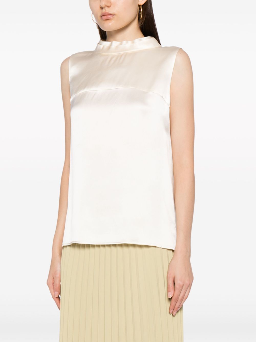 Ivory Chanel sleeveless silk satin top with mock-neck design, elegant and smooth fabric, perfect for stylish daytime or evening wear.