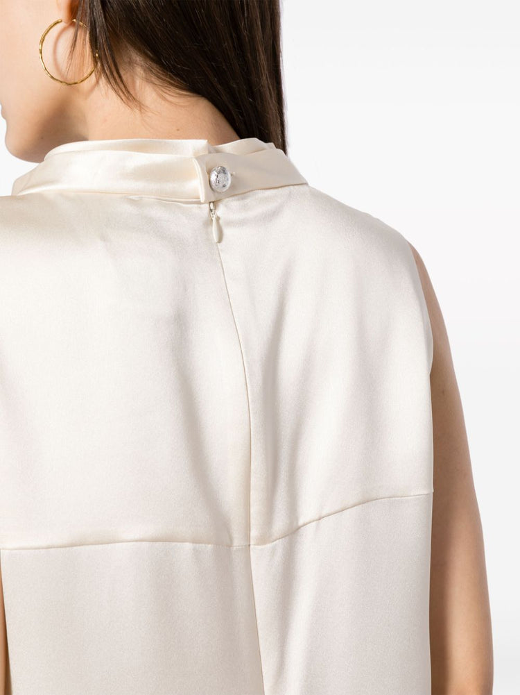 Ivory Chanel sleeveless silk satin top with mock neckline, elegant and smooth fabric, perfect for sophisticated fashion styles.