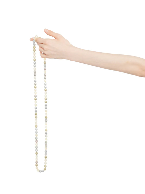 Chanel long pearl sautoir necklace with single strand of white pearls on a gold chain, elegant and classic jewelry piece.