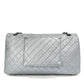 Back view of a metallic silver Chanel XXL airline travel flap bag with shoulder strap, showcasing sleek design and spacious interior.