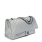 Silver metallic Chanel XXL airline travel flap bag with shoulder strap, side view showing sleek, spacious travel-ready design.