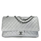 Metallic silver Chanel XXL airline travel flap bag with shoulder strap, showcasing its stylish design and spacious interior.