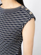 Navy and white Chanel jacquard boat-neck dress with a fitted silhouette and elegant pattern, displayed on a mannequin.