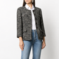 Chanel navy bouclé tweed jacket with collarless round neckline, long sleeves, textured navy and ivory weave, front button fastening, jewel-style buttons, and front pocket details.