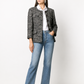 Chanel navy bouclé tweed jacket with collarless round neckline, long sleeves, textured navy and ivory weave, front button fastening, jewel-style buttons, and front pocket details.
