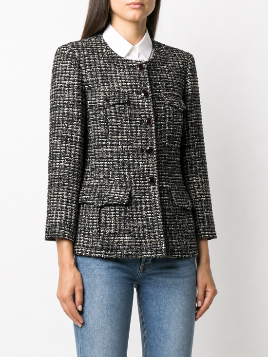 Chanel navy bouclé tweed jacket with collarless round neckline, long sleeves, textured navy and ivory weave, front button fastening, jewel-style buttons, and front pocket details.