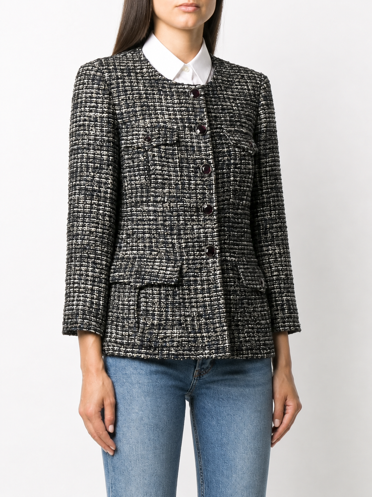 Chanel navy bouclé tweed jacket with collarless round neckline, long sleeves, textured navy and ivory weave, front button fastening, jewel-style buttons, and front pocket details.