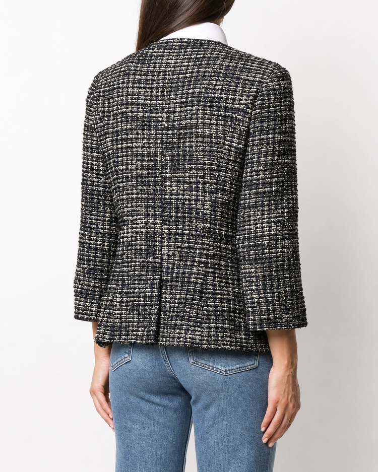 Chanel navy bouclé tweed jacket with collarless round neckline, long sleeves, textured navy and ivory weave, front button fastening, jewel-style buttons, and front pocket details.