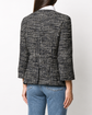 Chanel navy bouclé tweed jacket with collarless round neckline, long sleeves, textured navy and ivory weave, front button fastening, jewel-style buttons, and front pocket details.