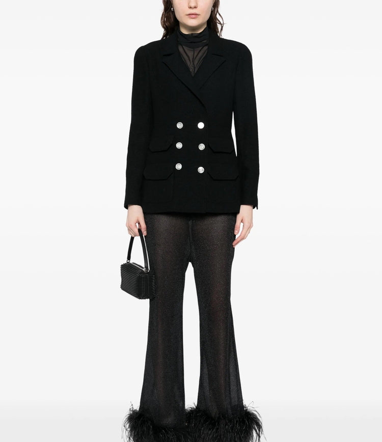 Navy double-breasted Chanel blazer with structured lapels and tailored fit, displayed on a hanger.