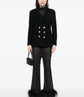 Navy double-breasted Chanel blazer with structured lapels and tailored fit, displayed on a hanger.