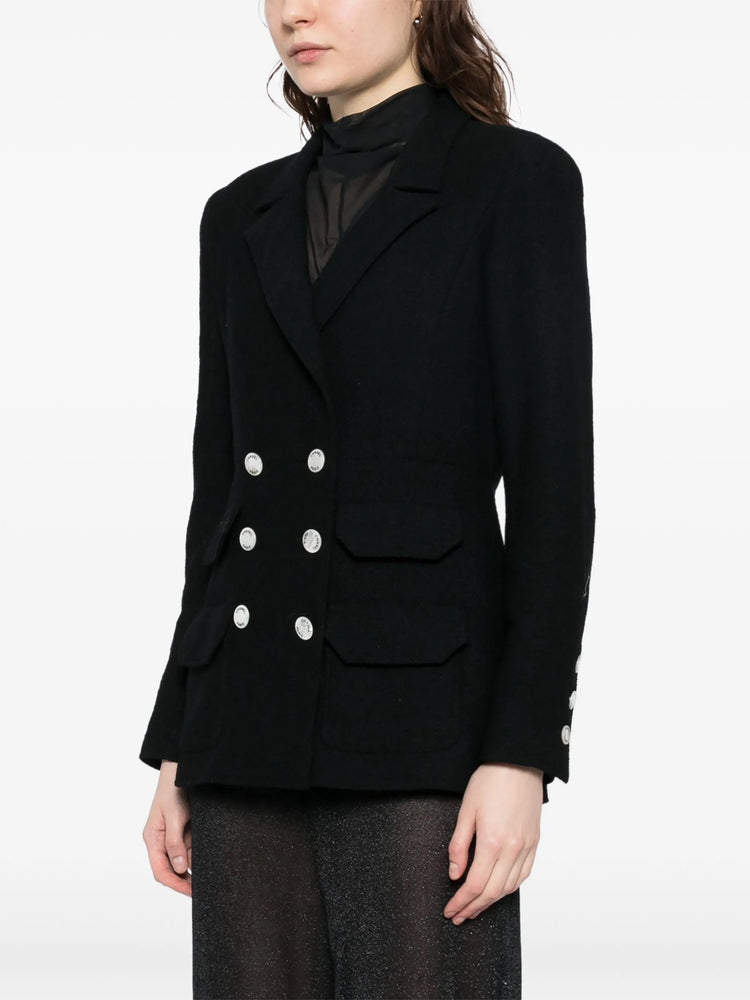Navy double-breasted Chanel blazer with structured lapels and tailored fit, shown on a mannequin.