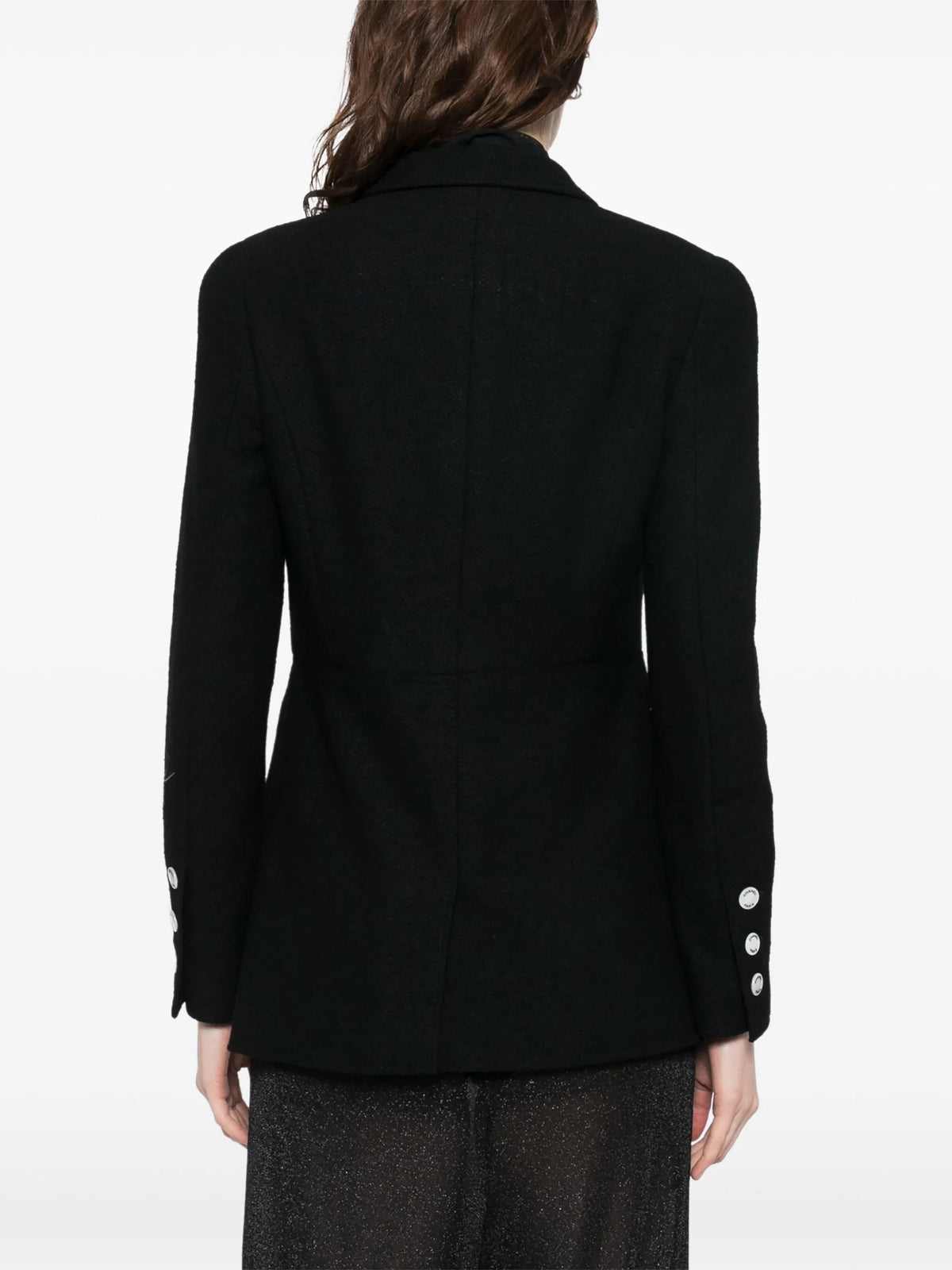 Navy double-breasted Chanel blazer with structured lapels and gold buttons, displayed on a hanger against a neutral background.
