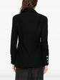 Navy double-breasted Chanel blazer with structured lapels and gold buttons, displayed on a hanger against a neutral background.