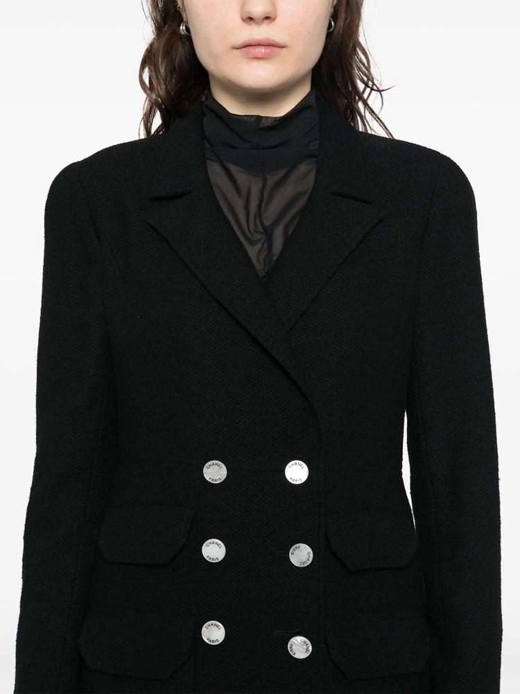 Navy double-breasted blazer by Chanel featuring tailored fit, classic lapels, and elegant design, ideal for sophisticated fashion.