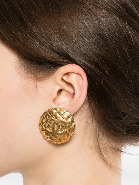 Chanel quilted gold clip-on earrings with a textured, luxurious design, showcasing elegant jewelry for fashionable accessories.