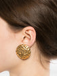 Chanel quilted gold clip-on earrings with a textured, luxurious design, showcasing elegant jewelry for fashionable accessories.