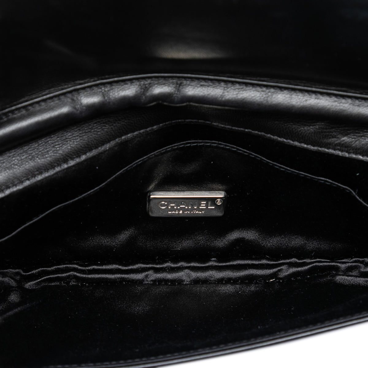 Chanel quilted lambskin butterfly clutch with chain strap, featuring a sleek, elegant design and signature quilting pattern.