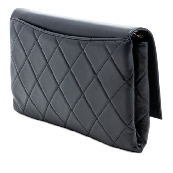Chanel black quilted lambskin retro clutch bag with fold-over flap, front Chanel logo plaque, silver-tone chain detail and slim rectangular silhouette.