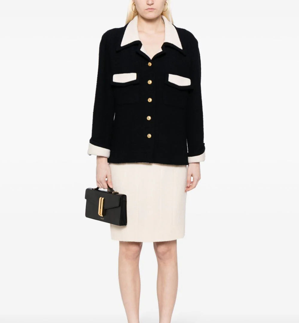 Chanel single-breasted bouclé skirt suit set featuring a tailored blazer and matching skirt in textured fabric.