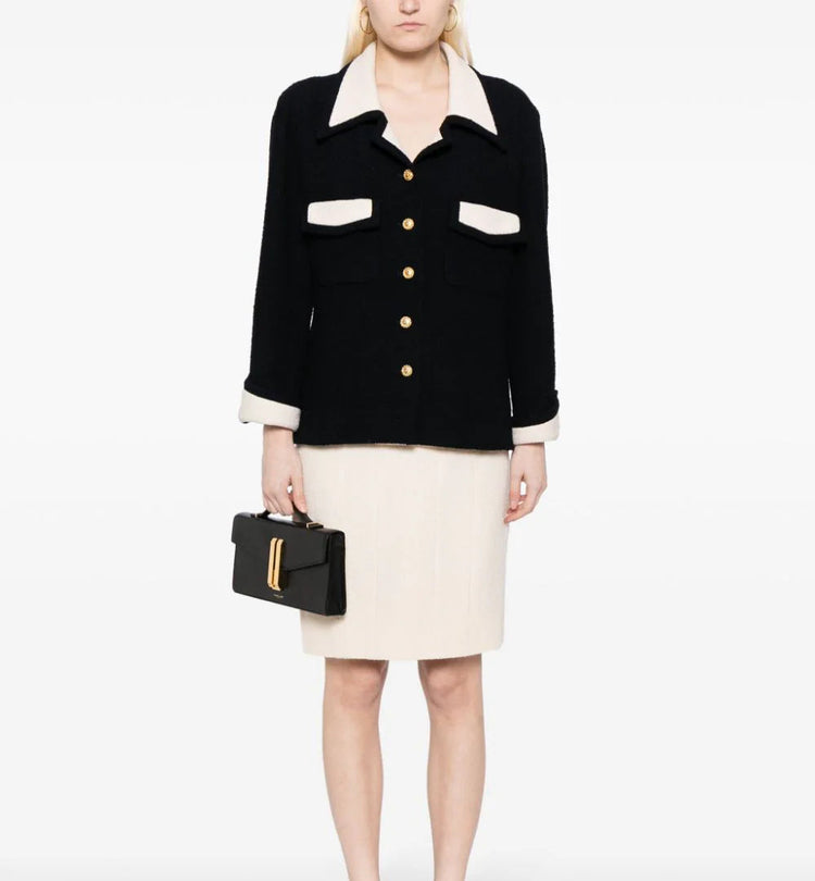 Chanel single-breasted bouclé skirt suit set featuring a tailored blazer and matching skirt in textured fabric.