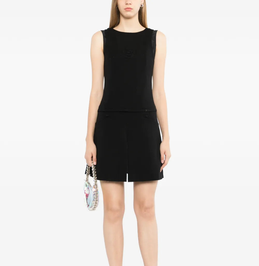 Chanel sleeveless Camellia wool dress featuring a fitted silhouette and floral embroidery, displayed on a mannequin.