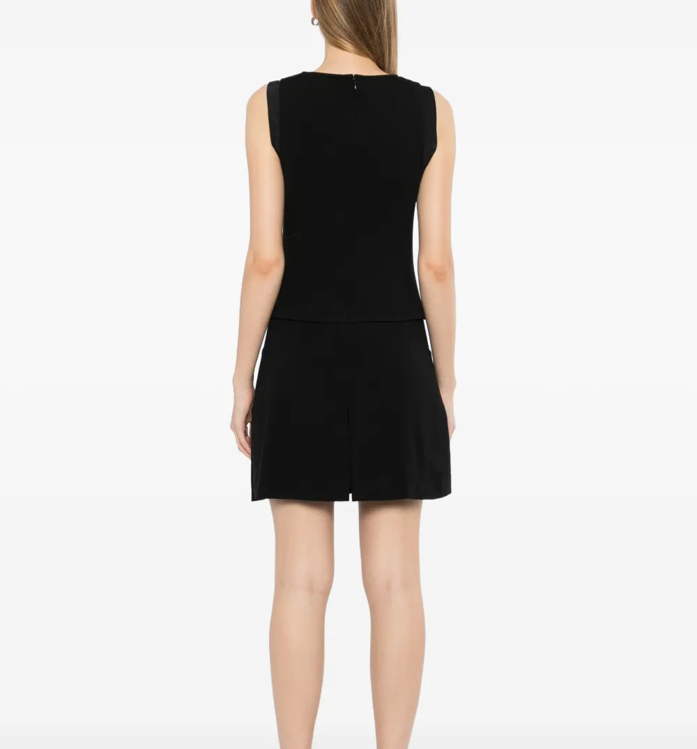 Chanel sleeveless Camellia wool dress featuring a fitted silhouette and elegant floral embroidery on soft wool fabric.
