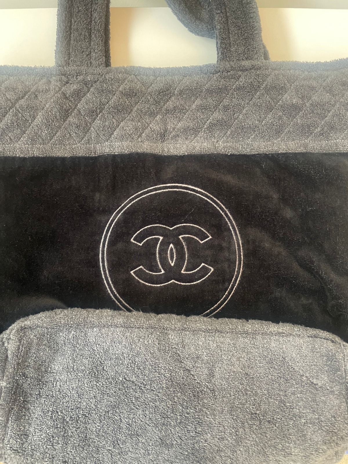 Chanel terry cloth tote bag with beige handles and spacious interior, stylish and practical for everyday use.