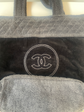 Chanel terry cloth tote bag with beige handles and spacious interior, stylish and practical for everyday use.