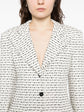 Chanel white and black textured tweed monochrome blazer with classic tailored fit, perfect for stylish formal or casual wear.
