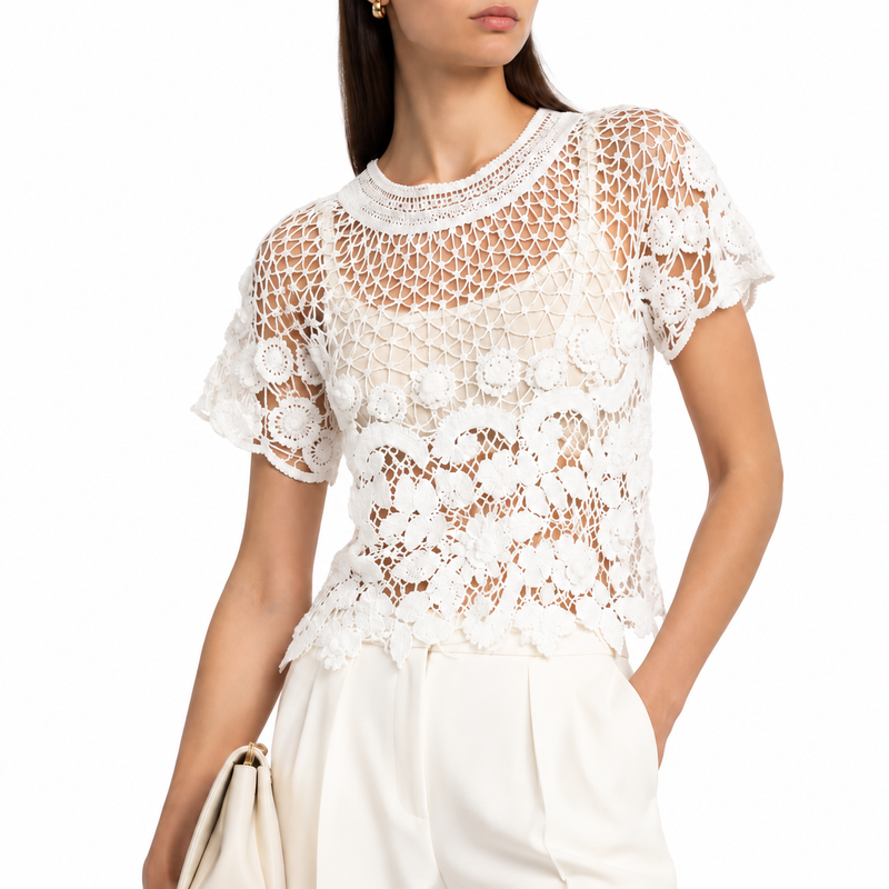 White crochet top by Chanel, cropped style with intricate knit details, perfect for stylish casual wear.