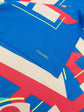 Blue Chanel silk scarf featuring a geometric logo design, showcasing elegant patterns and luxurious fabric.
