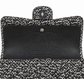 Silver tweed Chanel shoulder bag with sequins and a double flap design, featuring a chic, elegant style.