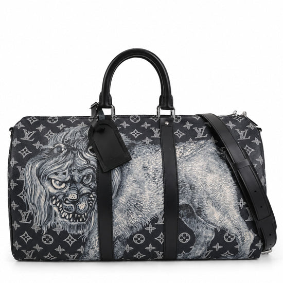 Louis Vuitton Chapman Brothers Keepall 55 Bandouliere travel bag in navy with lion print, featuring leather handles and adjustable strap.